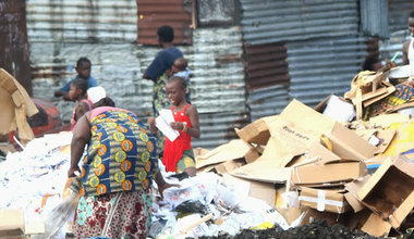 Women and their children looking for valuables in a trash dump in Kinshasa. Photo Radio Okapi /John Bompengo