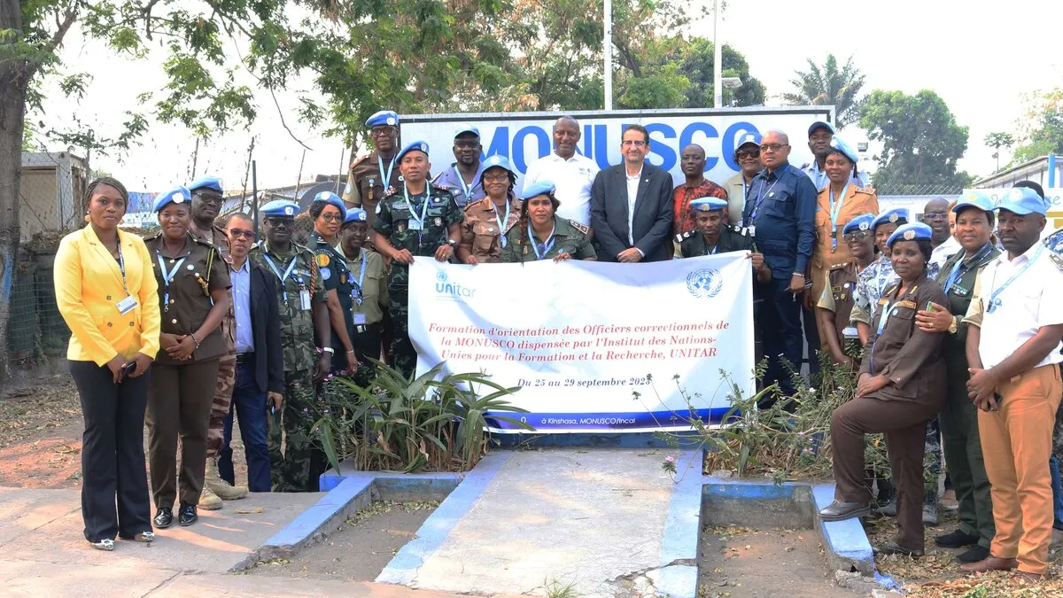 A group of peacekeepers standing together with a sign.