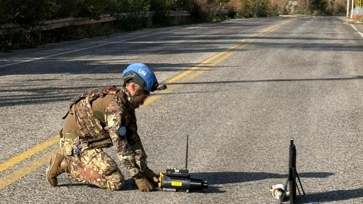 clearing road of crashed armed drone