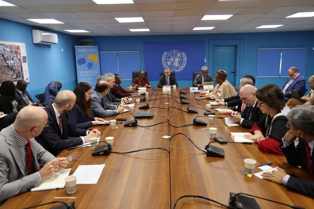 On the final day of his visit to #SouthSudan, UN Peacekeeping Chief, Jean-Pierre Lacroix, stressed the full commitment of #UNMISS to protecting civilians and supporting the peace process, despite new constraints caused by the UN-wide financial crisis. Meeting in a UN conference room with participants seated around a long wooden table, microphones and notebooks in front of them, and a UN emblem on the blue wall