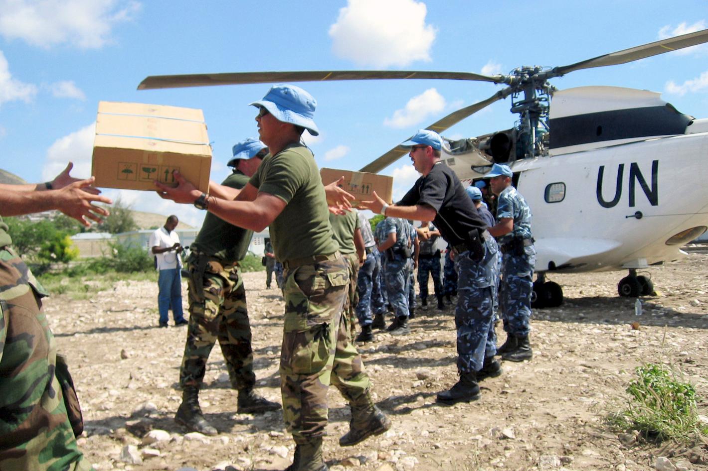 Humanitarian aid is disembarked from a United Nations helicopter.